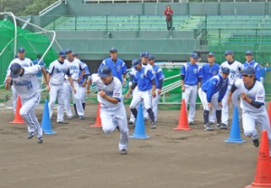 念入りなウオーミングアップを終えダッシュで汗を流す選手ら＝６日、市民球場