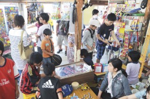 駄菓子を買い求める子どもや大人でにぎわう店内＝５日、瀬戸内町古仁屋