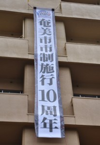 奄美市の市制施行１０周年を祝う懸垂幕＝４日、奄美市役所