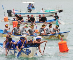 手に汗握るレースで観客を沸かせた龍郷ふるさと祭の舟こぎ競争＝２６日、龍郷町