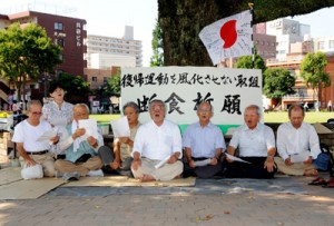 「断食祈願」を再現し、「日本復帰の歌」を歌う奄美出身者ら＝４日午前９時すぎ、鹿児島市中央町