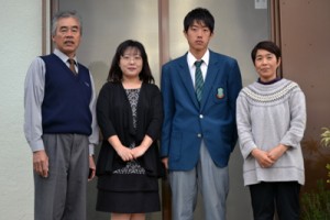 与論高校を卒業した奥野君親子（中央）と星砂荘の永井さん夫妻＝与論町