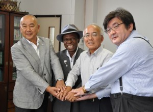 覚書を交わして握手する大久保明町長（中央右）とオスマン・サンコンさん（同左）ら＝２日、伊仙町