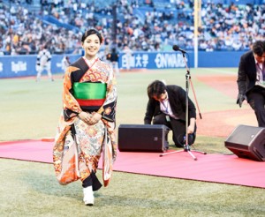 球場を埋めたファンの前で堂々と国歌を歌い笑顔を見せる城さん＝２８日、神宮球場