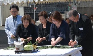 祭壇に献花して犠牲者のみ霊を慰める遺族ら＝２１日、徳之島町