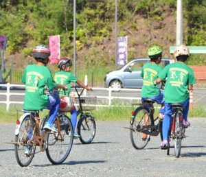 ヘルメットを着け、自転車に乗る児童たち＝９月２９日、龍郷町