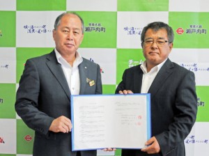 企業立地協定を結んだ桑山商事の桑山一成代表社員（右）と瀬戸内町の鎌田愛人町長＝１日、瀬戸内町役場