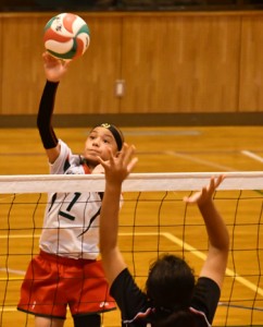 奄美女子との決勝でスパイクを決める朝日ＪＶＣ男子の松井琉空（左）＝１１日、奄美市笠利町の太陽が丘総合体育館