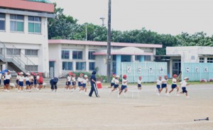 台風の影響で次第に風が強まる中、運動会に向けて練習をする児童ら＝２７日、和泊町の国頭小  