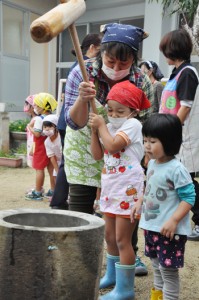 石臼ときねを使って本格的な餅つきを体験する子どもら＝７日、奄美市笠利町