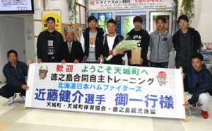 自主トレで徳之島入りした近藤選手（中央）ら選手と歓迎する天城町関係者＝５日、天城町徳之島空港