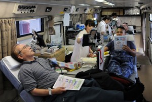 県赤十字センターのバス内で献血に協力する住民ら＝１９日、瀬戸内町