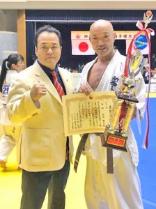 優勝を祝う安田さん（右）と与論町出身の入来武久師範（提供写真）