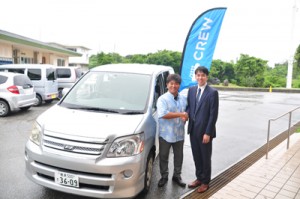 １２日から与論町内でアプリを活用した配車サービスの本格運用を始めるＡｚｉｔの須藤取締役（右）と、地元ドライバーの本園さん＝１１日、同町