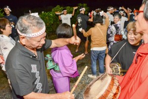 踊りの輪をつくる住民＝２５日、龍郷町中戸口