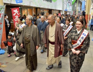 大島紬姿で商店街を練り歩き魅力をＰＲする参加者＝５日、奄美市名瀬  