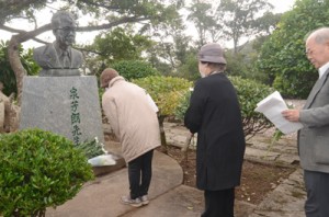 ６７年前に日本復帰を果たした先人たちをしのび、泉芳朗の胸像に献花する市民＝２５日、奄美市名瀬のおがみ山公園