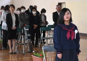 母・真奈美さん（左から３人目）や島民らが見守る中、入学式で校歌を歌う野崎凰さん（右）＝６日、瀬戸内町請島の池地中学校